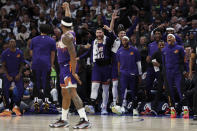 The Phoenix Suns bench celebrates guard Bradley Beal's 3-point basket against the Minnesota Timberwolves during the first half of an NBA basketball game, Sunday, April 14, 2024, in Minneapolis. (AP Photo/Matt Krohn)