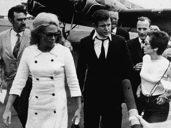 Kennedy, wearing a neck brace, and his wife Joan return from Kopechne’s funeral (Getty)