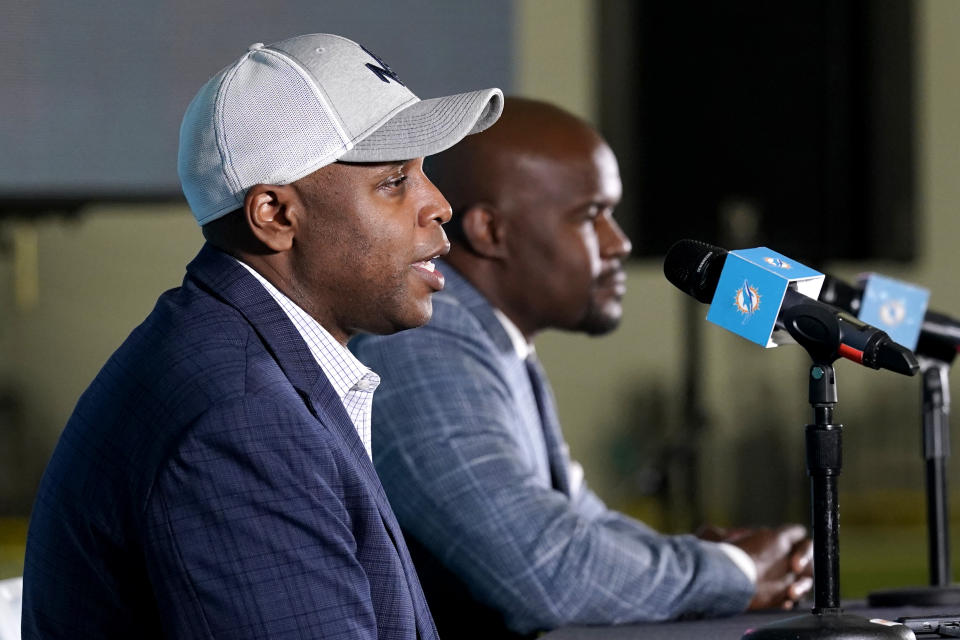 Miami Dolphins general manager Chris Grier, left, and coach Brian Flores speak during a news conference about players chosen by the Dolphins in the first round of the NFL football draft, early Friday, April 30, 2021, in Davie, Fla. (AP Photo/Lynne Sladky)