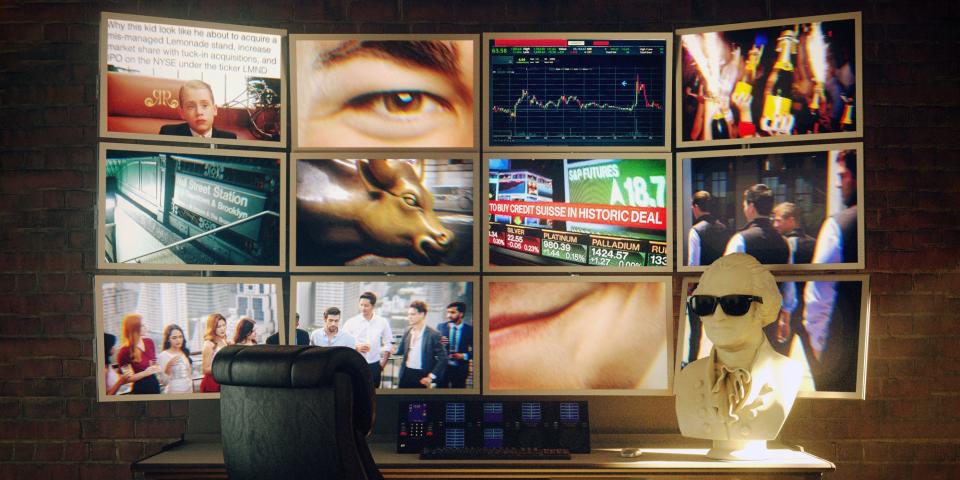 Screens showing various finance images in front of an empty chair