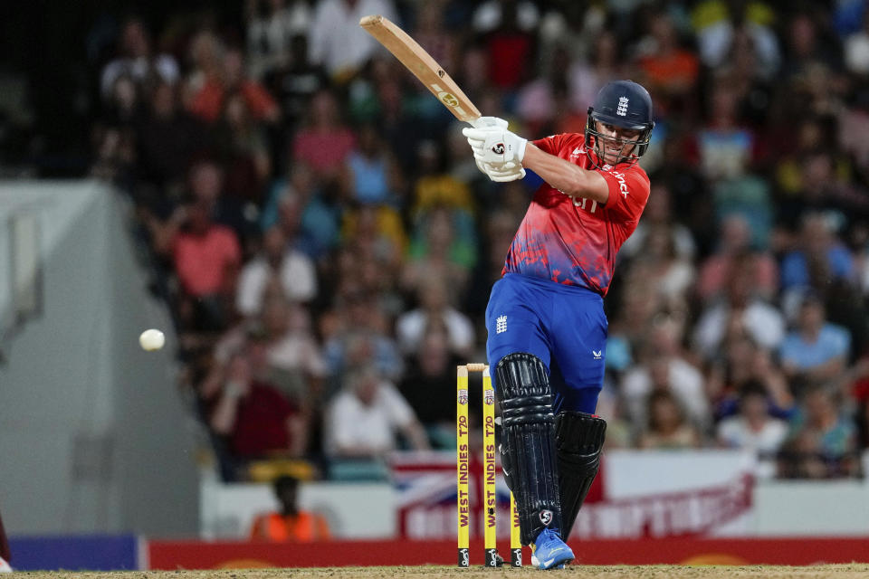 England's Sam Curran hits a four from the bowling of West Indies' Romario Shepherd during the first T20 cricket match at Kensington Oval in Bridgetown, Barbados, Tuesday, Dec. 12, 2023. (AP Photo/Ricardo Mazalan)