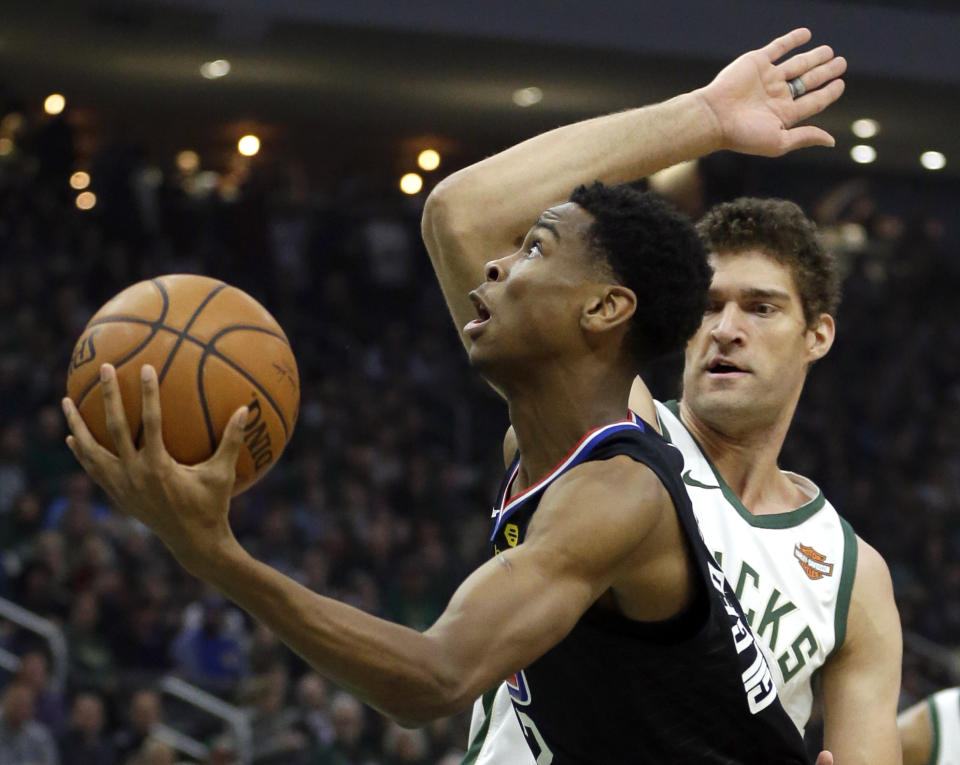 Los Angeles Clippers' Shai Gilgeous-Alexander shoots past Milwaukee Bucks' Brook Lopez during the first half of an NBA basketball game Thursday, March 28, 2019, in Milwaukee. (AP Photo/Aaron Gash)