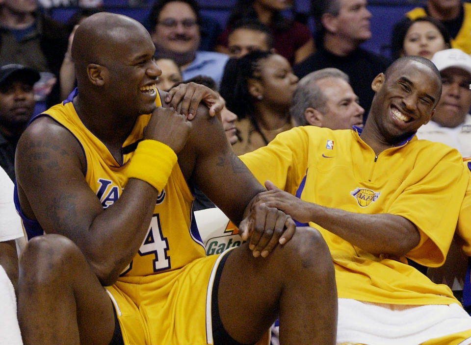 FILE - In this April 15, 2003, file photo, Los Angeles Lakers Shaquille O&#39;Neal, left, and Kobe Bryant share a laugh on the bench while their teammate take on the Denver Nuggets during the fourth quarter at Staples Center in Los Angeles. Bryant, the 18-time NBA All-Star who won five championships and became one of the greatest basketball players of his generation during a 20-year career with the Los Angeles Lakers, died in a helicopter crash Sunday, Jan. 26, 2020. (AP Photo/Kevork Djansezian, File)