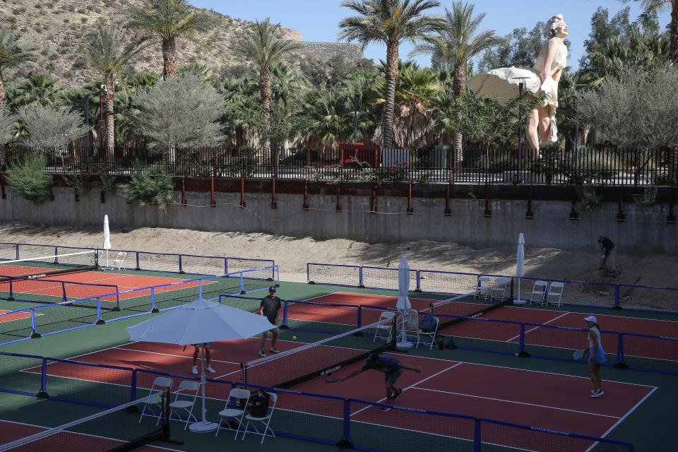 People play pickleball Thursday on one of the six new courts in the pit in between the Kimpton Rowan Hotel and the Palm Springs Art Museum in downtown Palm Springs.
