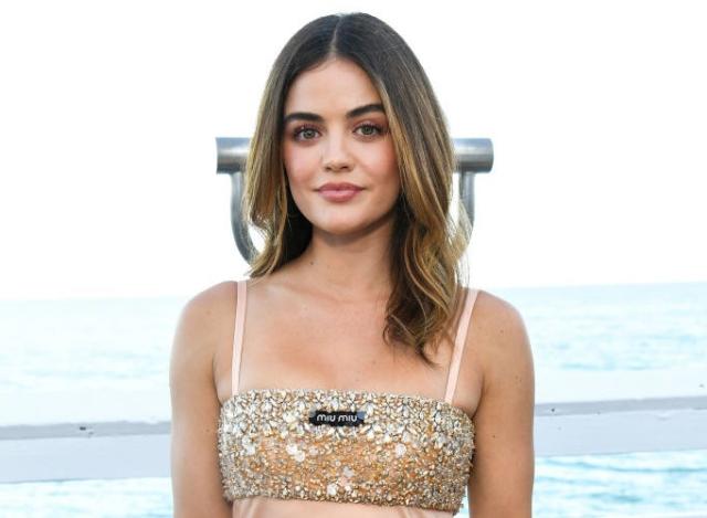 Lucy Hale is undeterred by heavy rainfall as she makes her way to