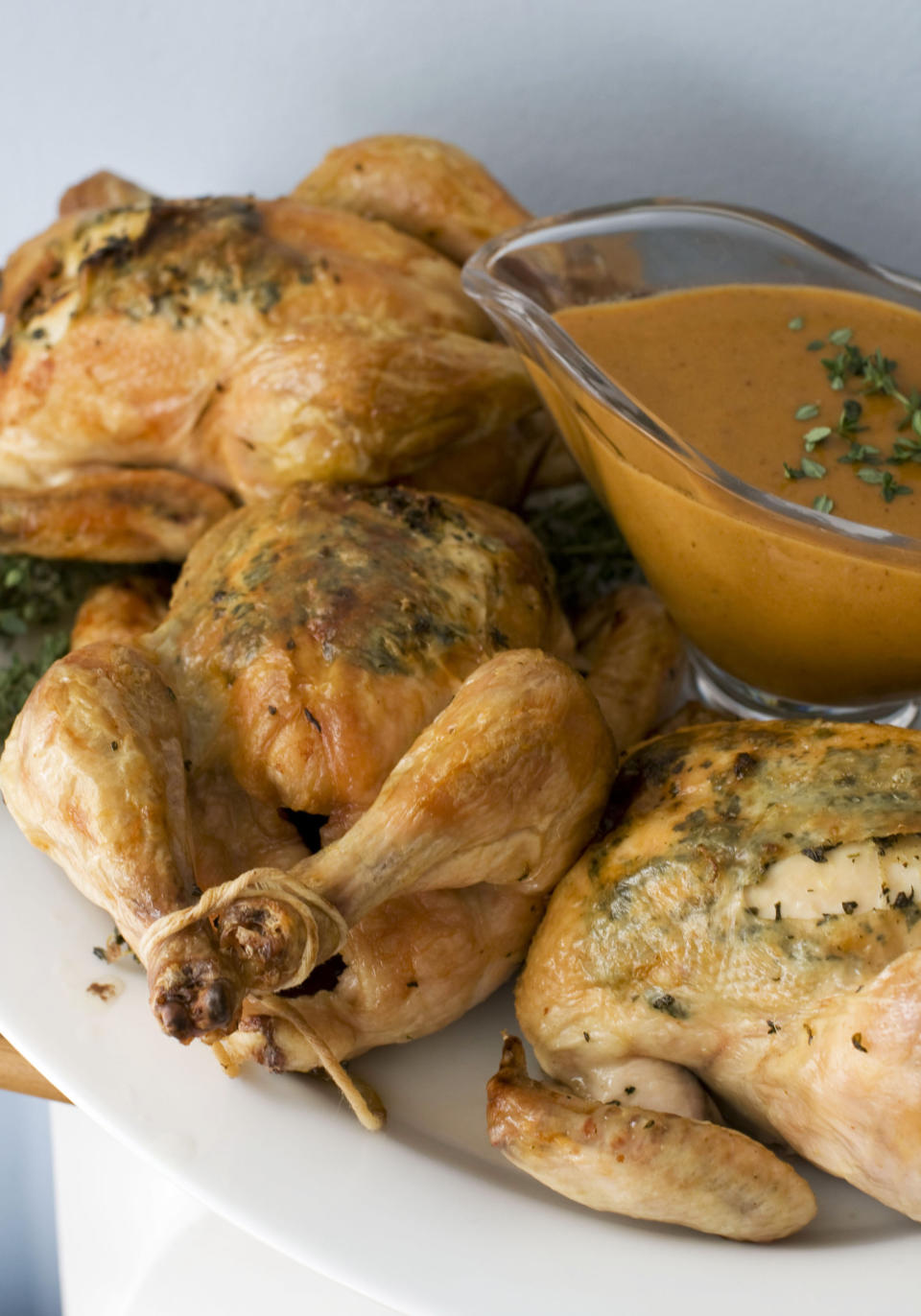 In this image taken on November 5, 2012, herb roasted Cornish game hens with creamy mustard sauce are shown served on a platter in Concord, N.H. (AP Photo/Matthew Mead)