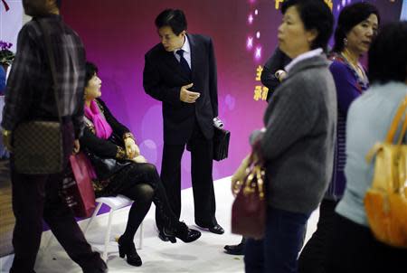 A man and a woman chat during a matchmaking event for middle-aged singles and seniors, sponsored by Shanghai's government, in Shanghai November 9, 2013. REUTERS/Carlos Barria