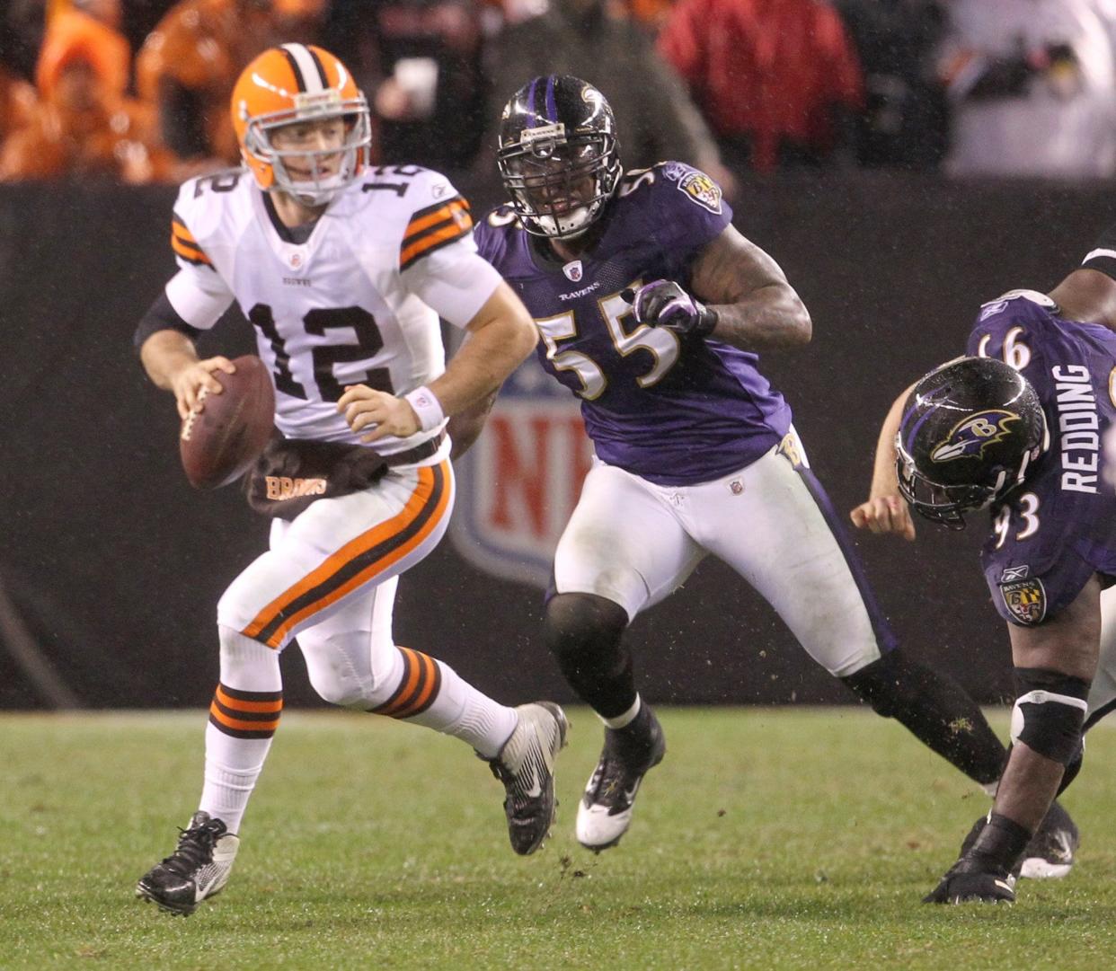 Cleveland Browns quarterback Colt McCoy is chased out of the pocket by Baltimore Ravens Terrell Suggs (center) and Corey Redding during third quarter at Cleveland Browns Stadium on Sunday, Dec. 4, 2011, in Cleveland, Ohio. The Ravens won the game 24-10.