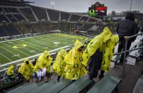 Oregon fans head to cover in Autzen Stadium due to a passing thunderstorm before Oregon plays Stony Brook in an NCAA college football game Saturday, Sept. 18, 2021, in Eugene, Ore. (AP Photo/Andy Nelson)