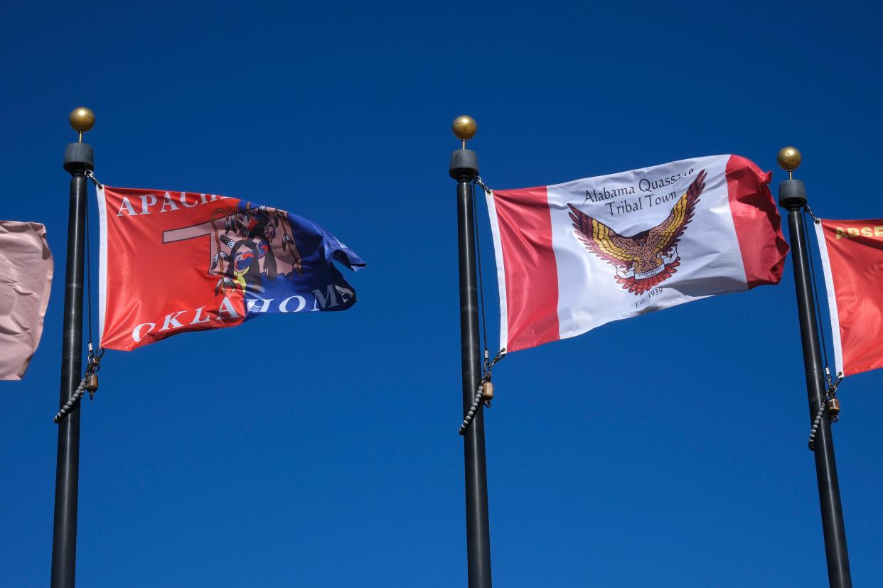 The flags of the Apache Tribe, left, and Alabama-Quassarte Tribal Town fly in the Tribal Flag Plaza north of the Oklahoma Capitol.