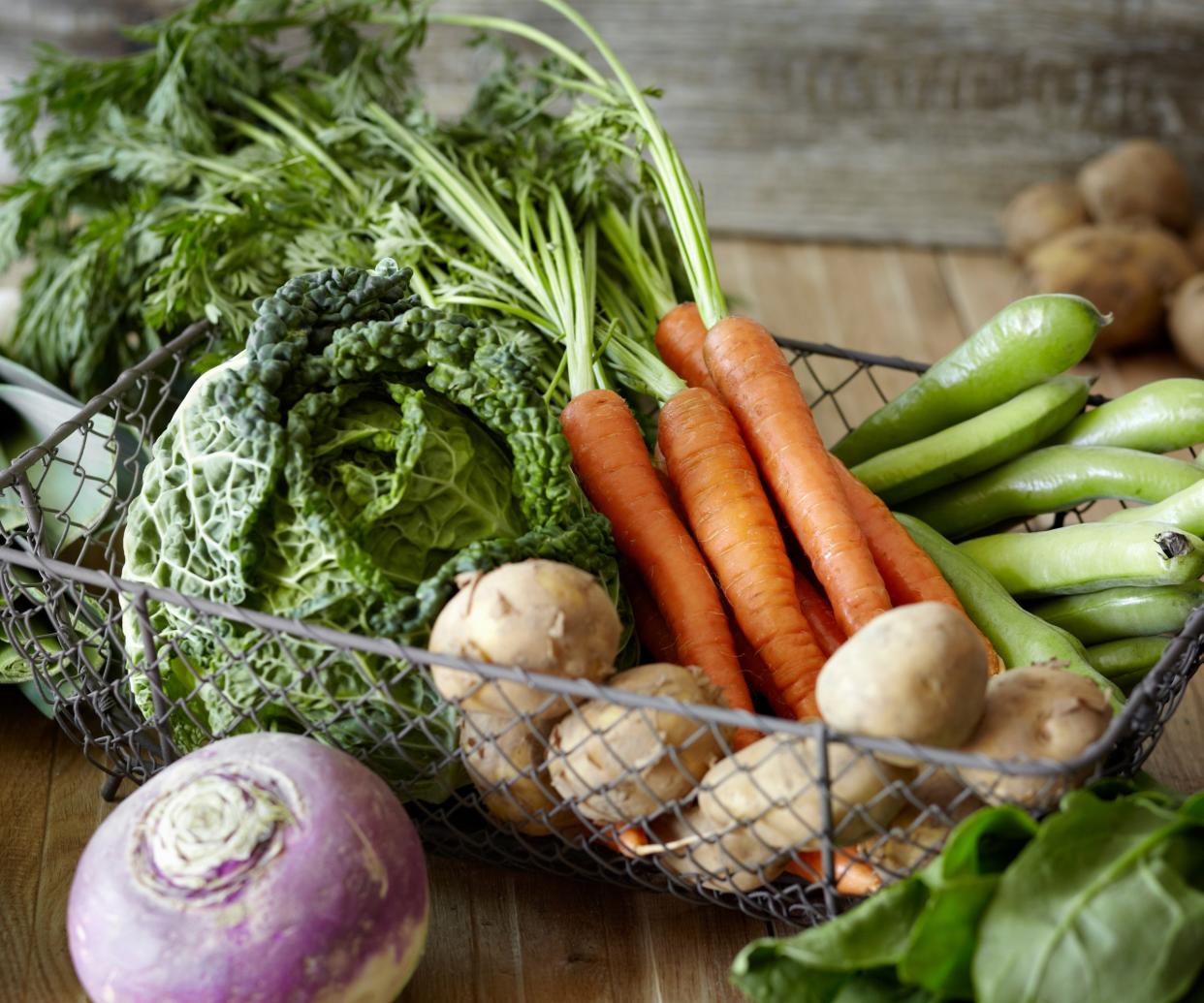  A selection of vegetables in a wire basket 