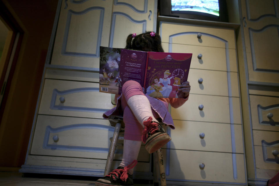 Lulu, a transgender girl, reads a book in her room at home in Buenos Aires on July 25, 2013. The 6-year-old Argentine child, who was listed as a boy at birth, has been granted new identification papers by the Buenos Aires provincial government listing her as a girl. According to her mother Gabriela, Lulu chose the gender as soon as she first learned to speak. Gabriela said her child, named Manuel at birth, has insisted on being called Lulu since she was just 4 years old, according to local media. Argentina in 2012 instituted liberal rules on changing gender, allowing people to alter their gender on official documents without first having to receive a psychiatric diagnosis or surgery.