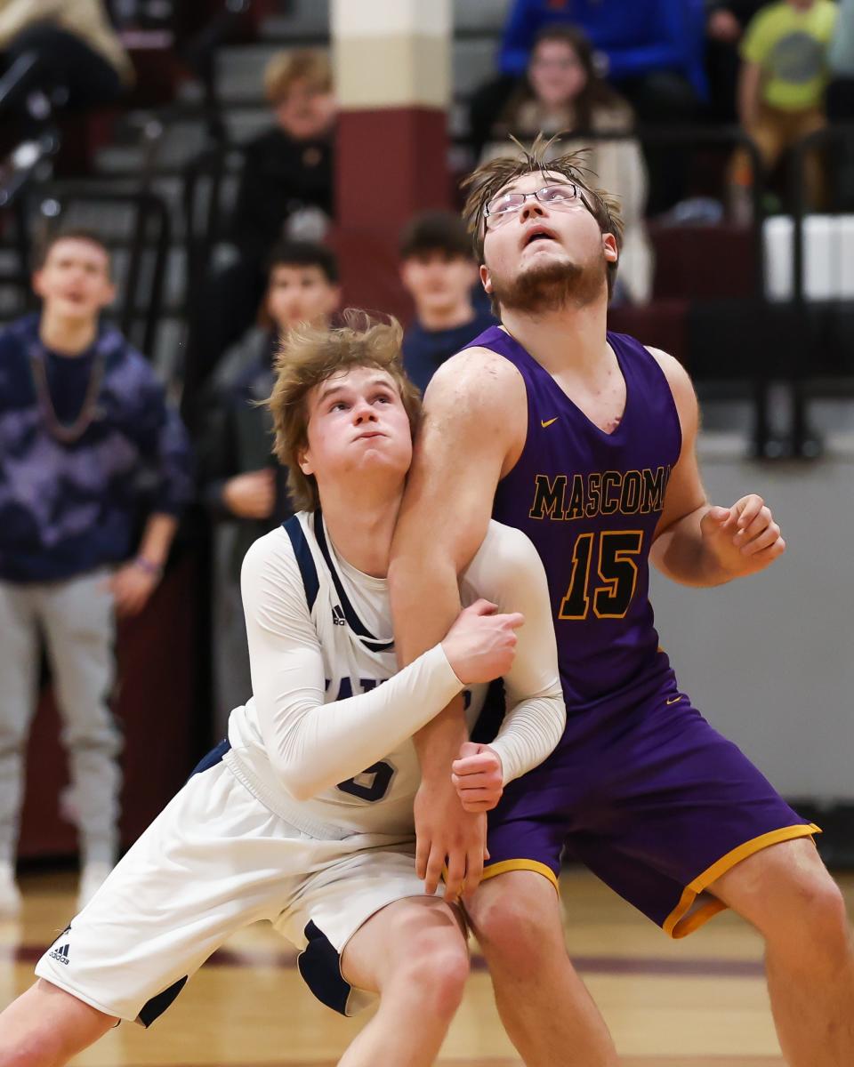 Mascoma's Tyler-Jay Mardin boxes out St. Thomas Aquinas' Devon Paquette during Wednesday's Division III boys basketball semifinal at Goffstown High School.