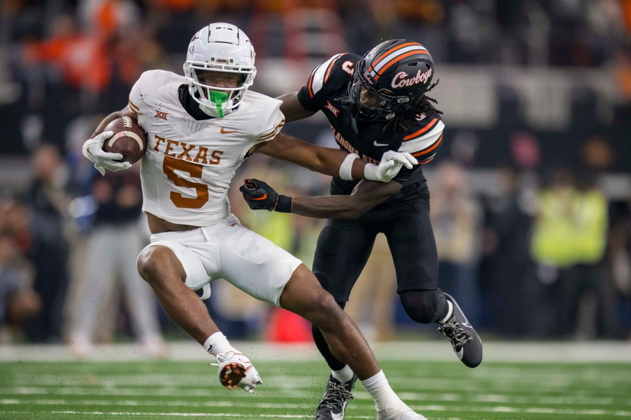 Dec 2, 2023; Arlington, TX, USA; Texas Longhorns wide receiver Adonai Mitchell (5) and Oklahoma State Cowboys cornerback Cam Smith (3) in action during the game between the Texas Longhorns and the Oklahoma State Cowboys at AT&T Stadium.