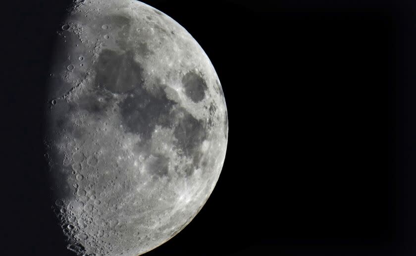 FILE - Impact craters cover the surface of the moon, seen from Berlin, Germany, Tuesday, Jan. 11, 2022. The moon is about to get walloped by 3 tons of space junk, a punch that will carve out a crater that could fit several semitractor-trailers. A leftover rocket is expected to smash into the far side of the moon at 5,800 mph (9,300 kph) on Friday, March 4, 2022, away from telescopes' prying eyes. It may take weeks, even months, to confirm the impact through satellite images. (AP Photo/Michael Sohn, File)