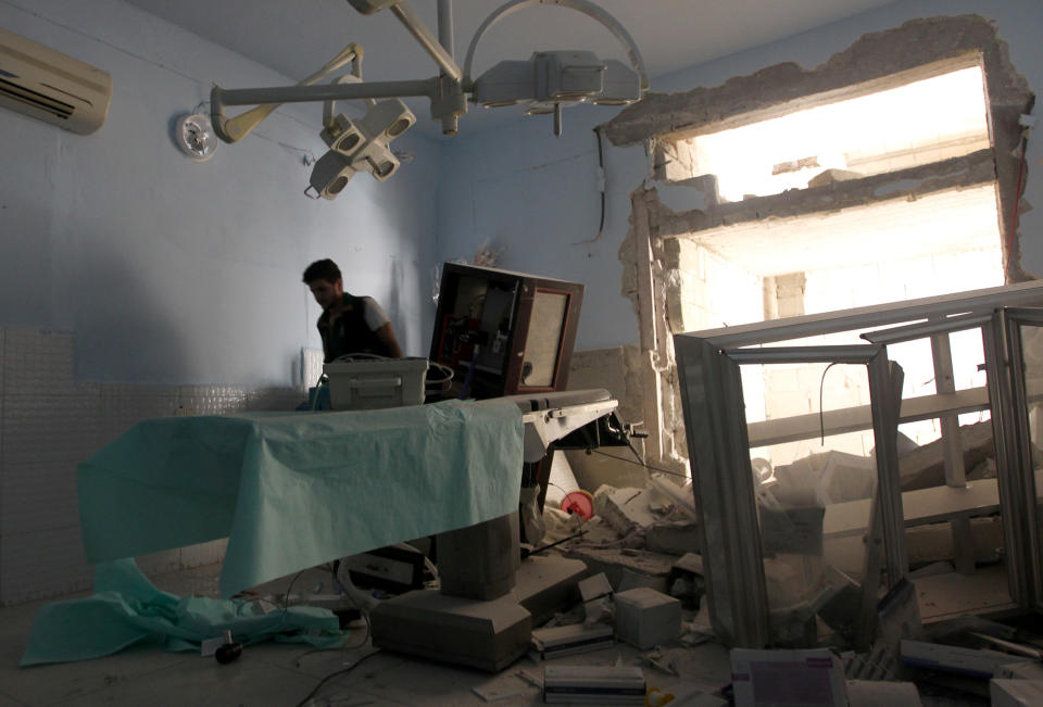 A medic inspects the damage inside Anadan Hospital, sponsored by Union of Medical Care and Relief Organizations (UOSSM), after it was hit yesterday by an airstrike in the rebel held city of Anadan, northern Aleppo province, Syria on July 31, 2016.