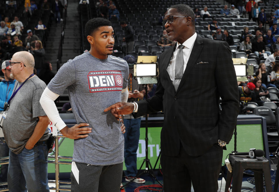 Denver Nuggets guard Gary Harris, left, chats with Atlanta Hawks announcer Dominique Wilkins before an NBA basketball game Tuesday, Nov. 12, 2019, in Denver. (AP Photo/David Zalubowski)