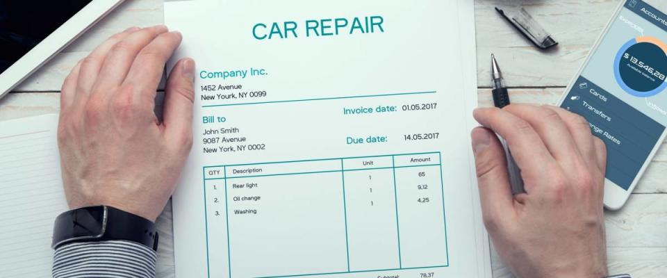 Car repair invoice on the table.