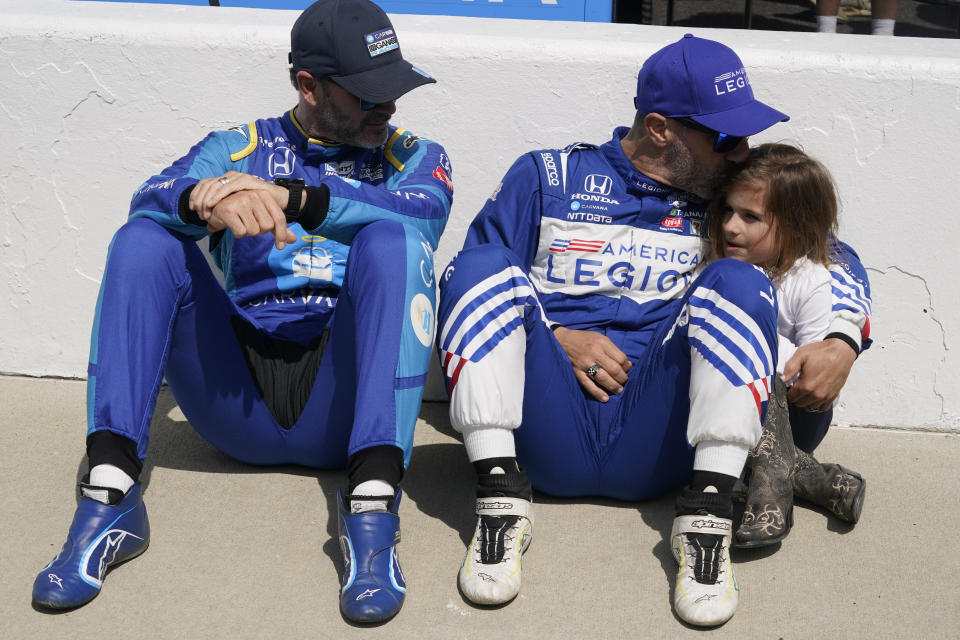 Alex Palou, center, of Spain, hugs Sofia Franchitti, right, as Jimmie Johnson, left, watches before qualifications for the Indianapolis 500 auto race at Indianapolis Motor Speedway, Sunday, May 22, 2022, in Indianapolis. (AP Photo/Darron Cummings)