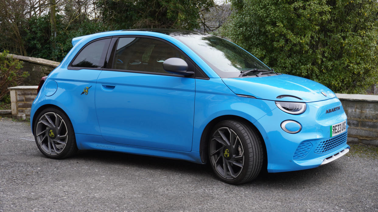  The Abarth 500e Turismo in Poison Blue, sat on a gravel driveway. 