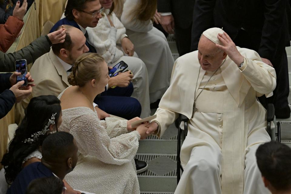 Pope Francis greets newlywed couples during the weekly general audience at the Vatican on Wednesday.
