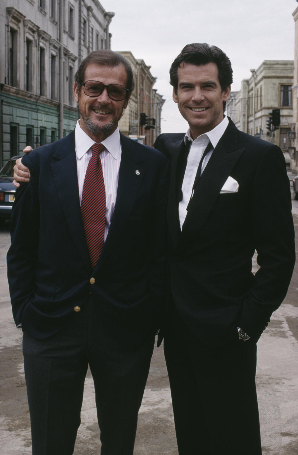 Irish actor Pierce Brosnan poses with Roger Moore, a former incarnation of superspy James Bond, on the set of the film 'GoldenEye', 1995. (Photo by Keith Hamshere/Getty Images)