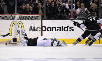 Los Angeles Kings center Anze Kopitar, right, of Slovenia, scores on San Jose Sharks goalie Alex Stalock during the third period in Game 6 of an NHL hockey first-round playoff series, Monday, April 28, 2014, in Los Angeles. The Kings won 4-1. (AP Photo)