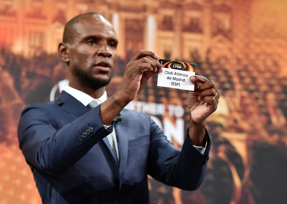 Former French soccer player and ambassador for the UEFA Europa League final in Lyon Eric Abidal shows the slip of Atletico de Madrid during the draw for the semi-finals round of the UEFA Europa League football tournament at the UEFA headquarters in Nyon