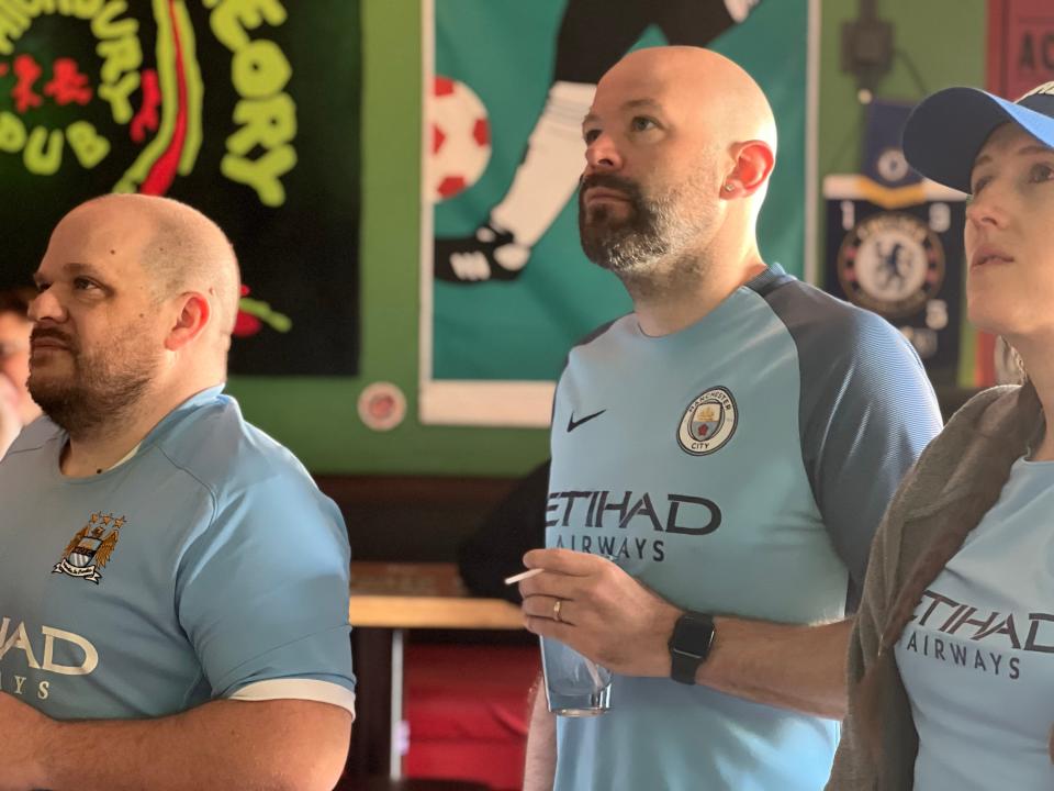 Kyle Charters, center, organizer with the Cream Cityzens, the Milwaukee Manchester City fan club, watches a match with his fellow supporters.