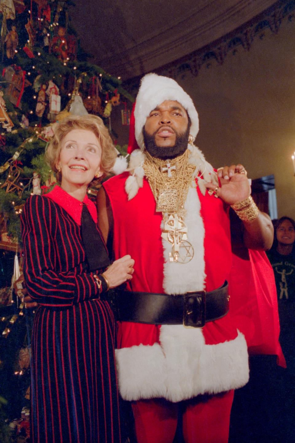 Nancy Reagan with Mr. T dressed as Santa in 1983.