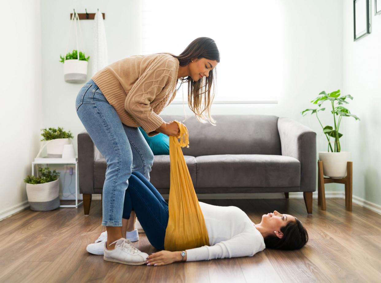 An image of a doula helping a pregnant woman.