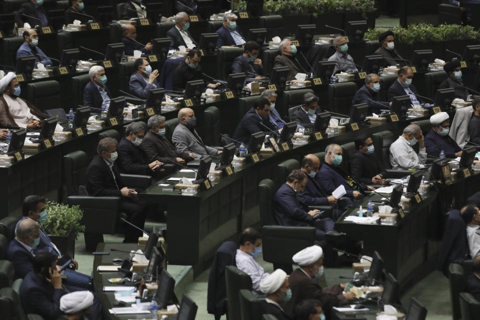 Lawmakers attend an open session of parliament to debate the proposed ministers of President Ebrahim Raisi's new cabinet, in Tehran, Iran, Wednesday, Aug. 25, 2021. Iran's hard-liner dominated parliament Wednesday voted to approve most of the proposed ministers by the recently elected president. (AP Photo/Vahid Salemi)