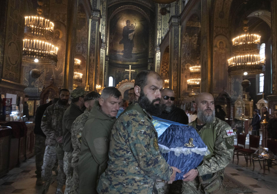 Volunteers of the Georgian legion carry the coffin during the funeral ceremony for Georgian volunteer Edisher Kvaratskhelia killed in a battlefield, at St. Volodymyr Cathedral in Kyiv, Ukraine, Thursday, Oct. 13, 2022. (AP Photo/Efrem Lukatsky)