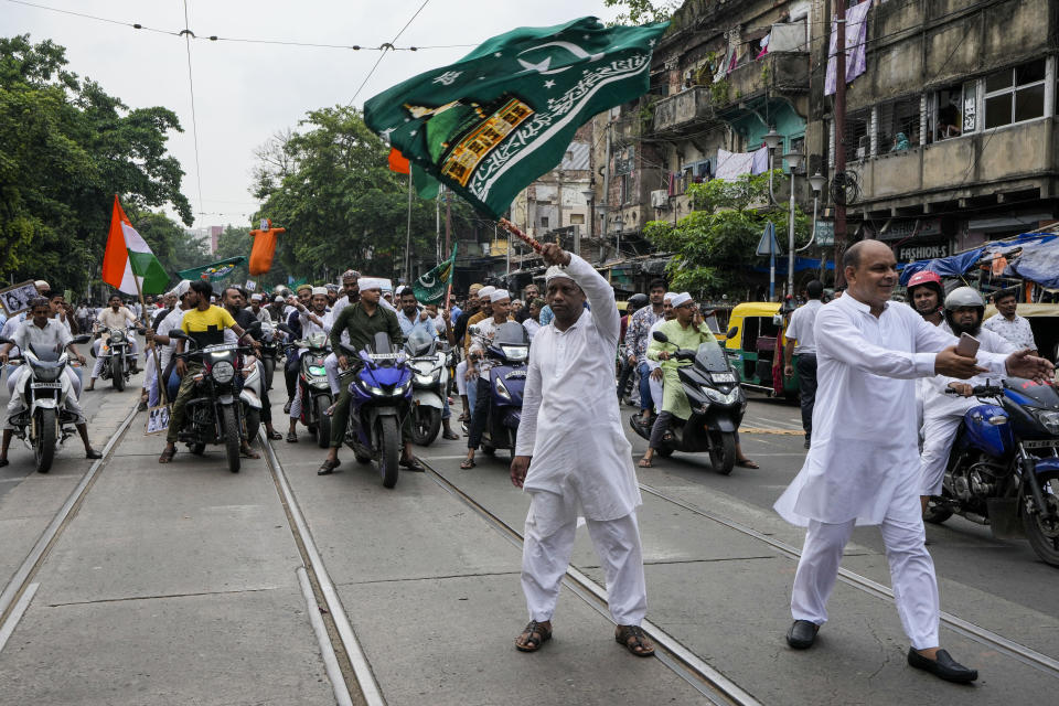 Indian Muslims block road as they protest against the spokesperson of governing Hindu nationalist party as they react to the derogatory references to Islam and the Prophet Muhammad in Kolkata, India, Friday, June 10, 2022. Thousands of Muslims emerging from mosques after Friday prayers held street protests and hurled rocks at the police in some Indian towns and cities over remarks by two officials from India’s ruling party that were derogatory to the Prophet Muhammad. (AP Photo/Bikas Das)