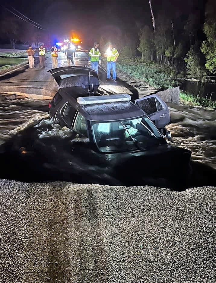 An Oconto County Sheriff's Office squad is seen partially submerged in water on County A in the town of Maple Valley. The vehicle ran into the washout out on May 12.