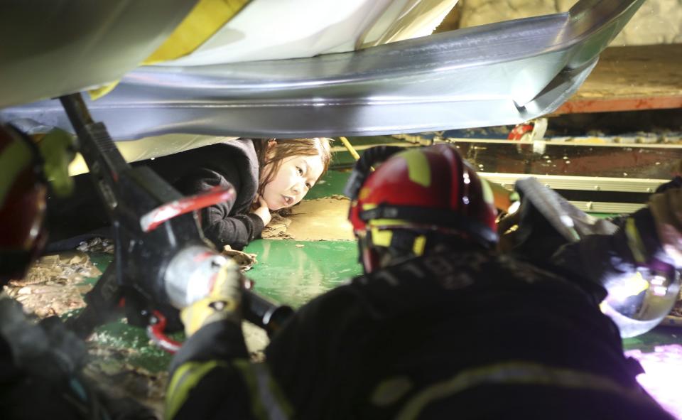 Firefighters try to rescue a university student trapped by debris from the collapsed resort in Gyeongju