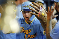 Milwaukee Brewers' Mike Brosseau is congratulated by teammates after hitting a solo home run against the Toronto Blue Jays during the third inning of a baseball game Saturday, June 25, 2022, in Milwaukee. (AP Photo/Jon Durr)