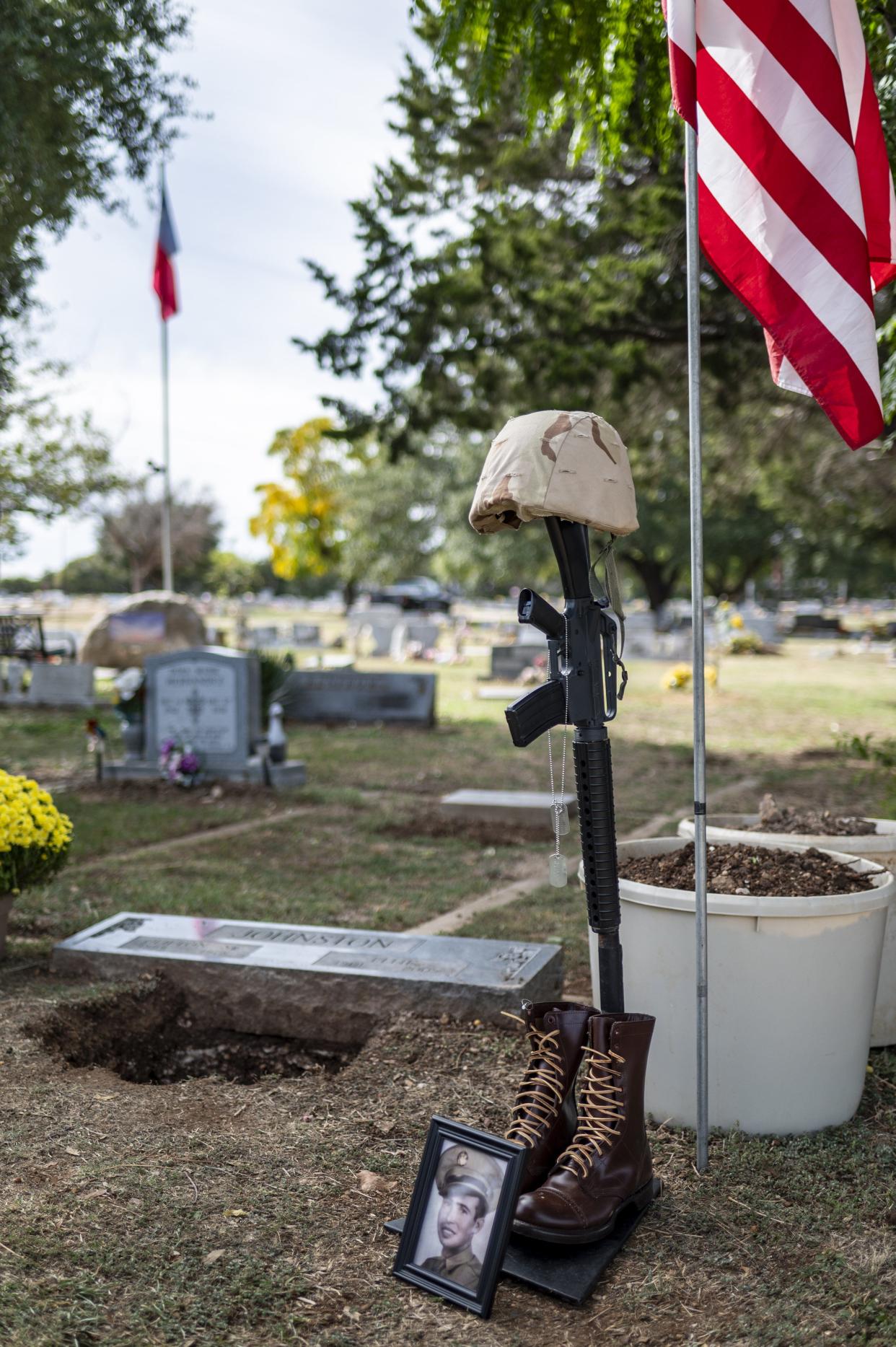 A marker and photo of Sgt. Turner Yearwood Johnston sit near his final resting place in Belton on Saturday Oct. 21, 2023. His remains were buried alongside the graves of his parents.