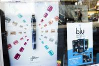 Advertisements for e-cigarettes hang at the window of a tobacco store in New York April 24, 2014. REUTERS/Lucas Jackson