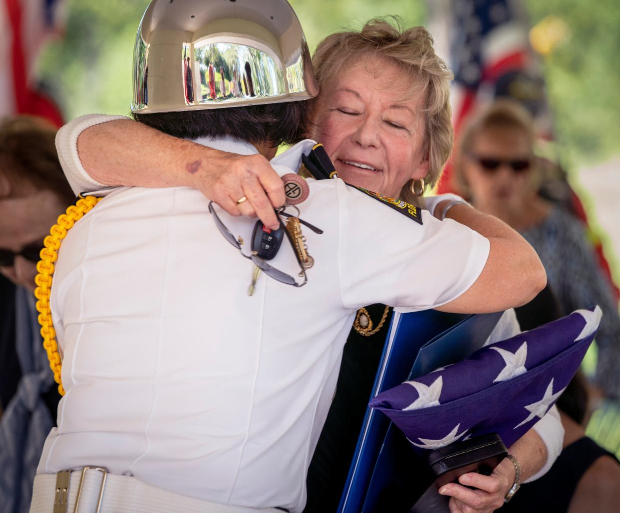 A member of the honor guard hugs Betty Rhodes after a ceremony Wednesday at the South Florida National Cemtery for her cousin, Army Pfc. Roy J. Searle of Graniteville, Rhode Island, who was killed during World War II near Rehlingen, Germany in December 1944.