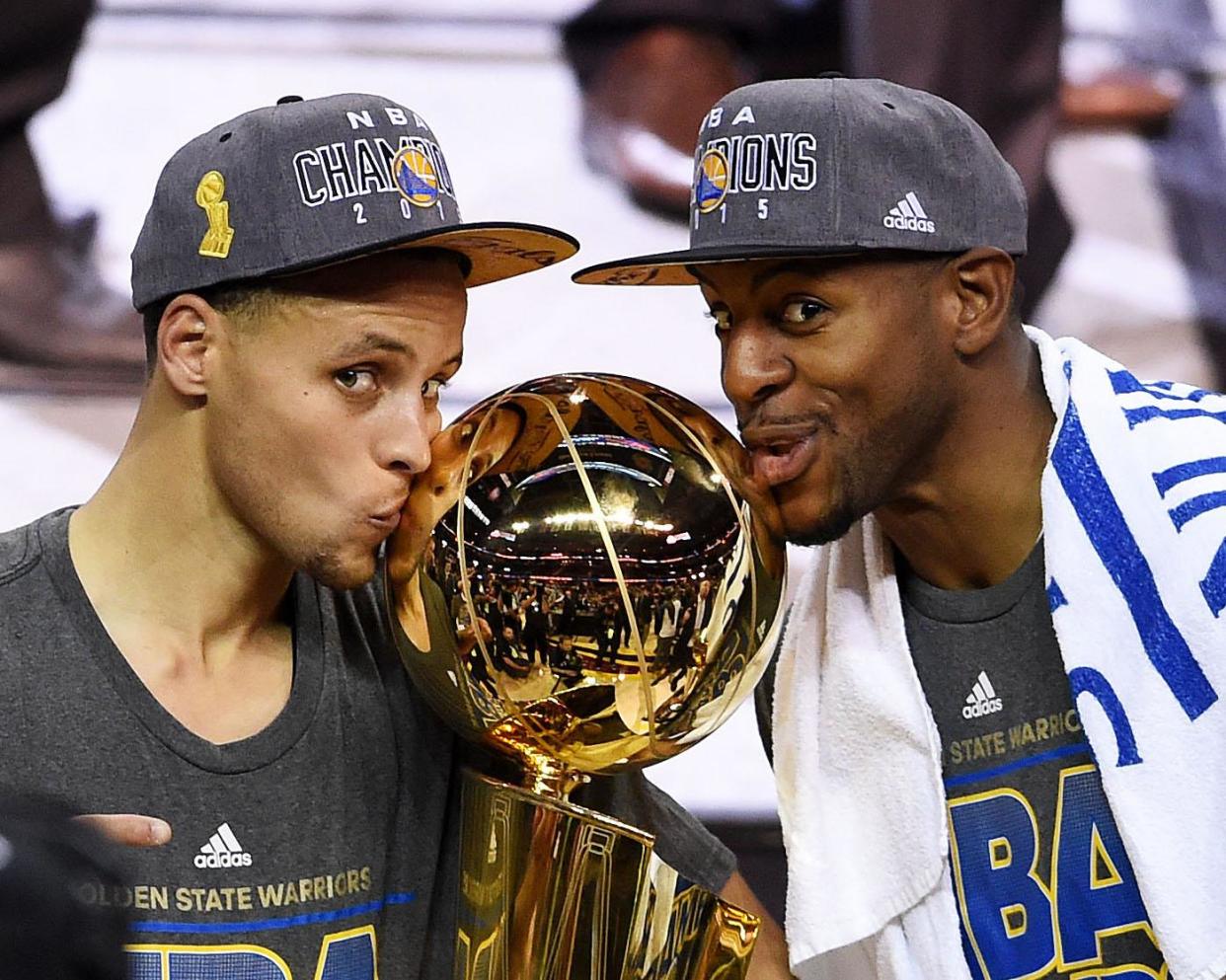 Stephen Curry (l) and Andre Iguodala celebrate with the NBA championship trophy in 2015: Getty Images