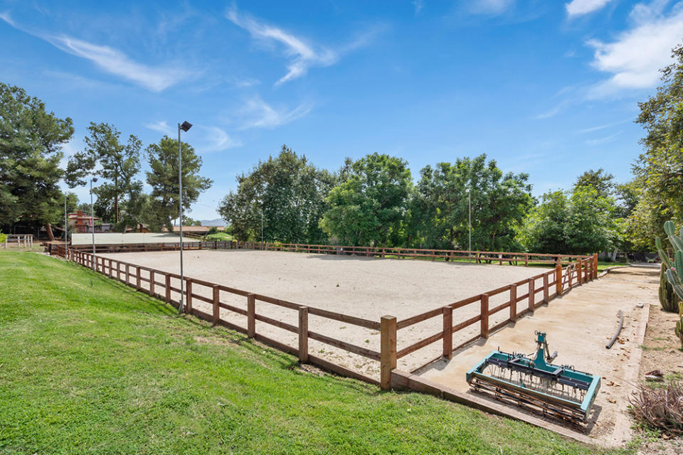 The equestrian estate includes an 11-stall barn and a lighted riding ring.