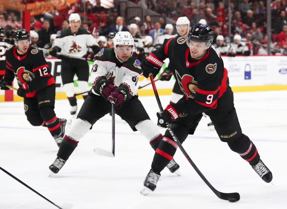 Ottawa Senators center Josh Norris (9) takes a shot on net as Arizona Coyotes left wing Matias Maccelli (63) defends during the second period of an NHL hockey game in Ottawa, Ontario on Saturday, Oct. 22, 2022. (Sean Kilpatrick/The Canadian Press via AP)