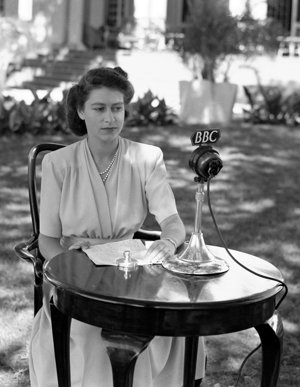 FILE - Britain's Princess Elizabeth, later Queen Elizabeth II, poses in front of a microphone to make a 21st Birthday speech, April 21, 1947, which she made from Cape Town, South Africa. Queen Elizabeth II will mark 70 years on the throne Sunday, Feb. 6, 2022, an unprecedented reign that has made her a symbol of stability as the United Kingdom navigated an age of uncertainty. (AP Photo, File)