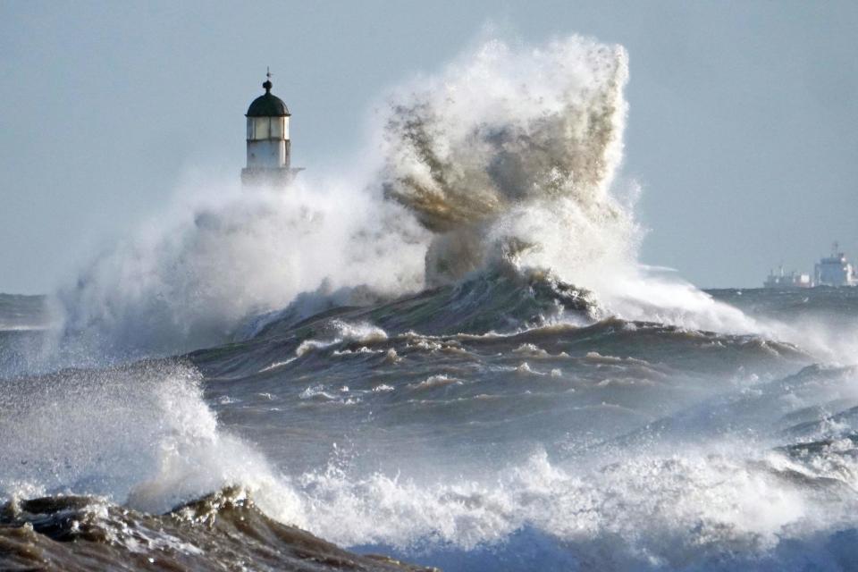 Waves crash against the pier wall at Seaham Lighthouse on the County Durham on Monday: PA