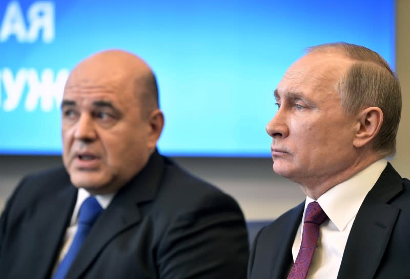 FILE PHOTO: Russian President Putin attends a meeting with head of the Federal Taxation Service Mishustin in Moscow