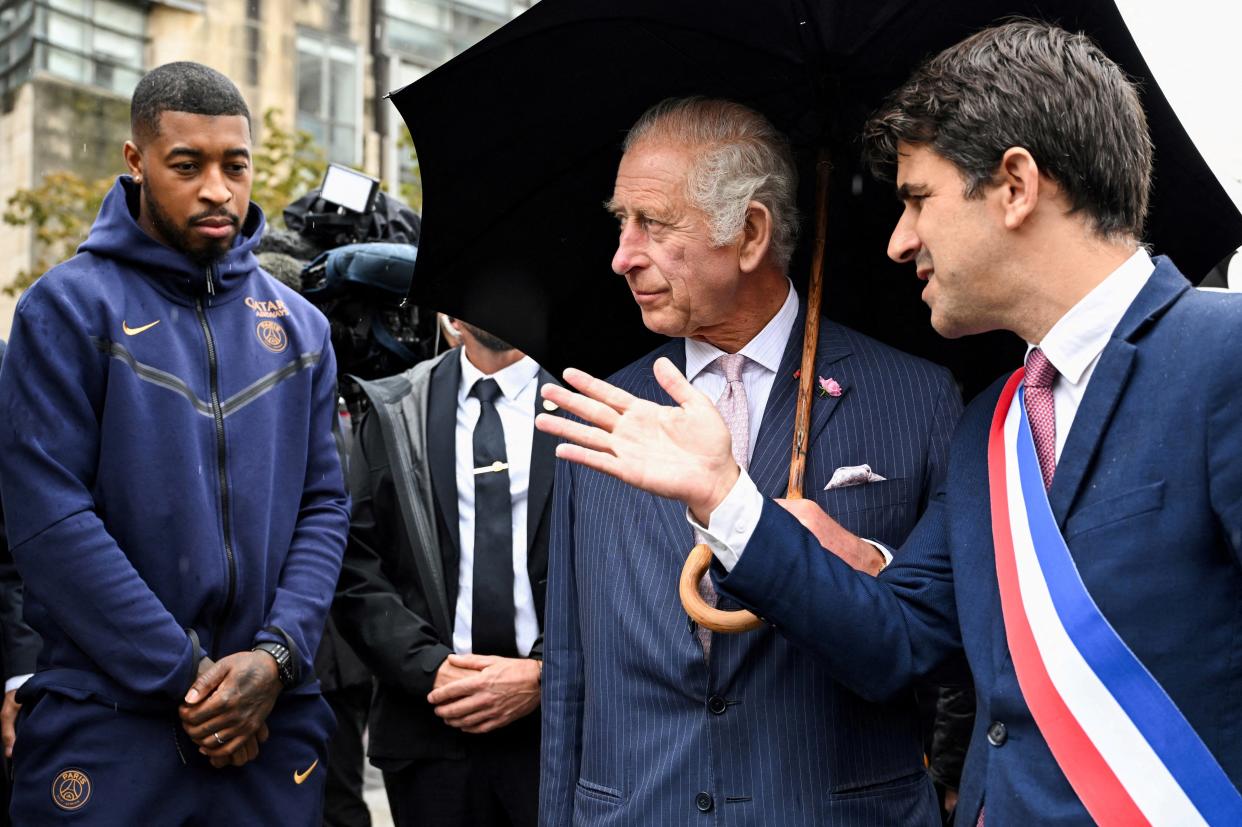 Mayor of Saint-Denis Mathieu Hanotin speaks with Britain's King Charles III, next to Paris Saint-Germain's French defender Presnel Kimpembe (via REUTERS)
