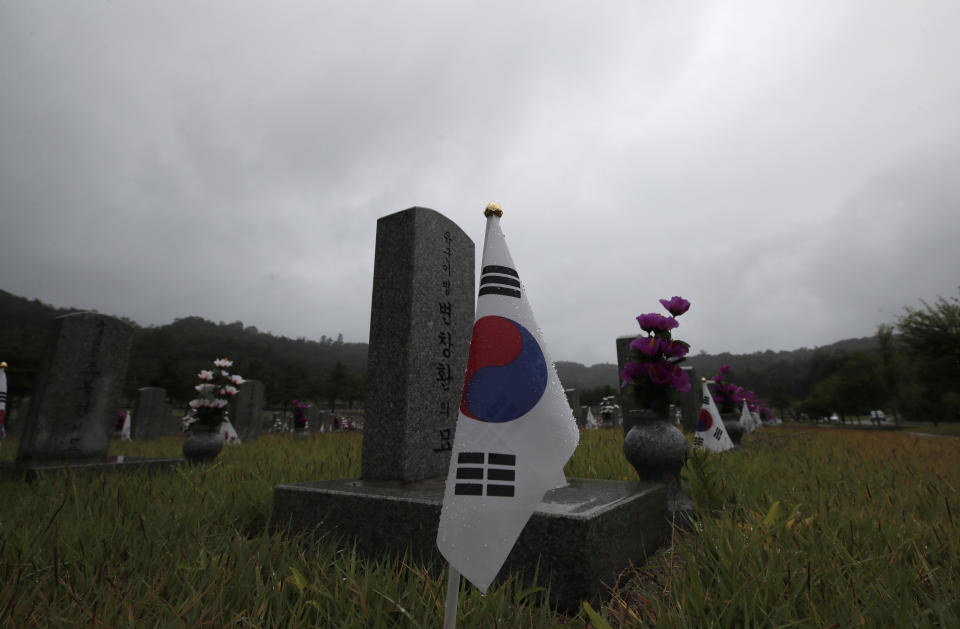 South Korean national flags are placed near the gravestones of soldiers who died during the 1950-1953 Korean War at the National Cemetery in Seoul, South Korea, Thursday, June 25, 2020. North and South Korea on Thursday marked the 70th anniversary of the start of the Korean War with largely subdued commemorations amid the coronavirus pandemic, a day after the North abruptly halted a pressure campaign against the South. (AP Photo/Lee Jin-man)