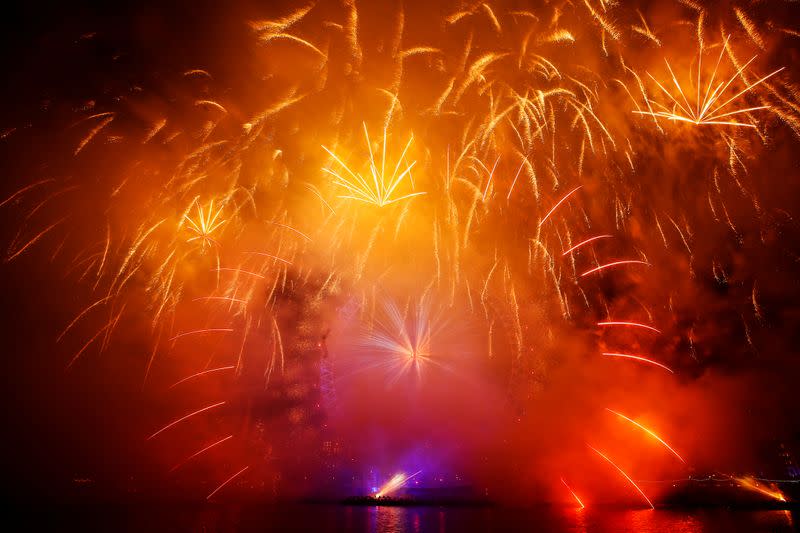 Fireworks explode over the London Eye wheel during New Year celebrations in central London