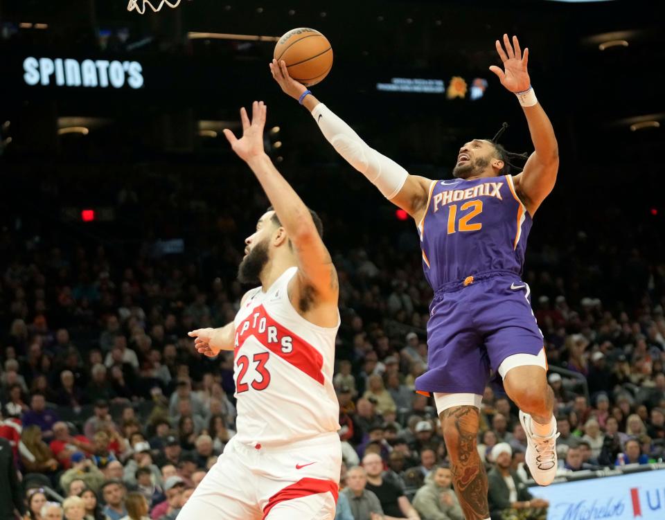 Phoenix Suns forward Ish Wainright (12) lays the ball in against Toronto Raptors guard Fred VanVleet (23) during the first quarter at Footprint Center in Phoenix on Jan. 30, 2023.